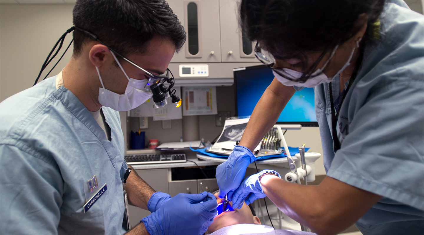 Orthodontists working on a patient