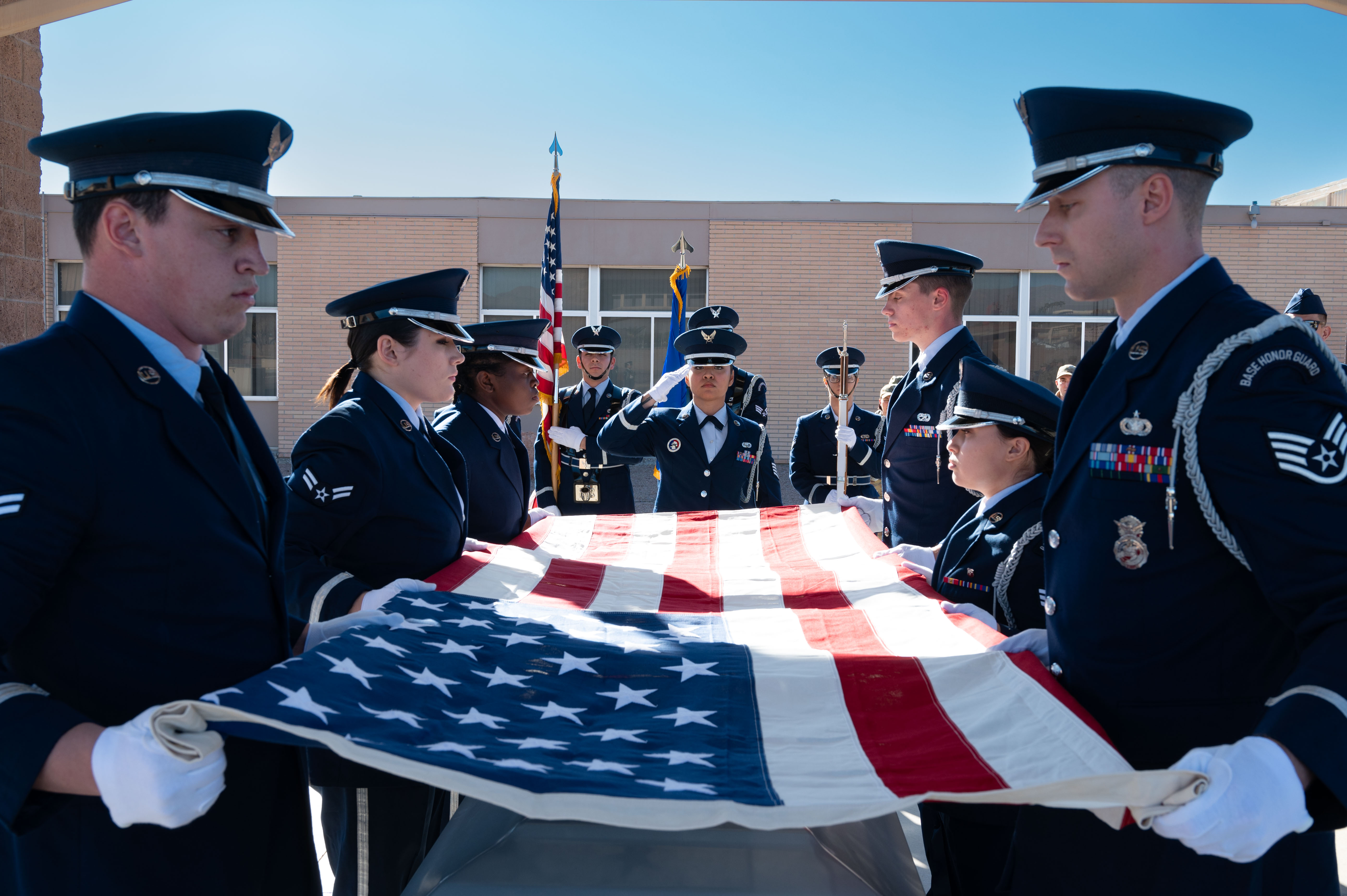 honor guard airmen holding flag