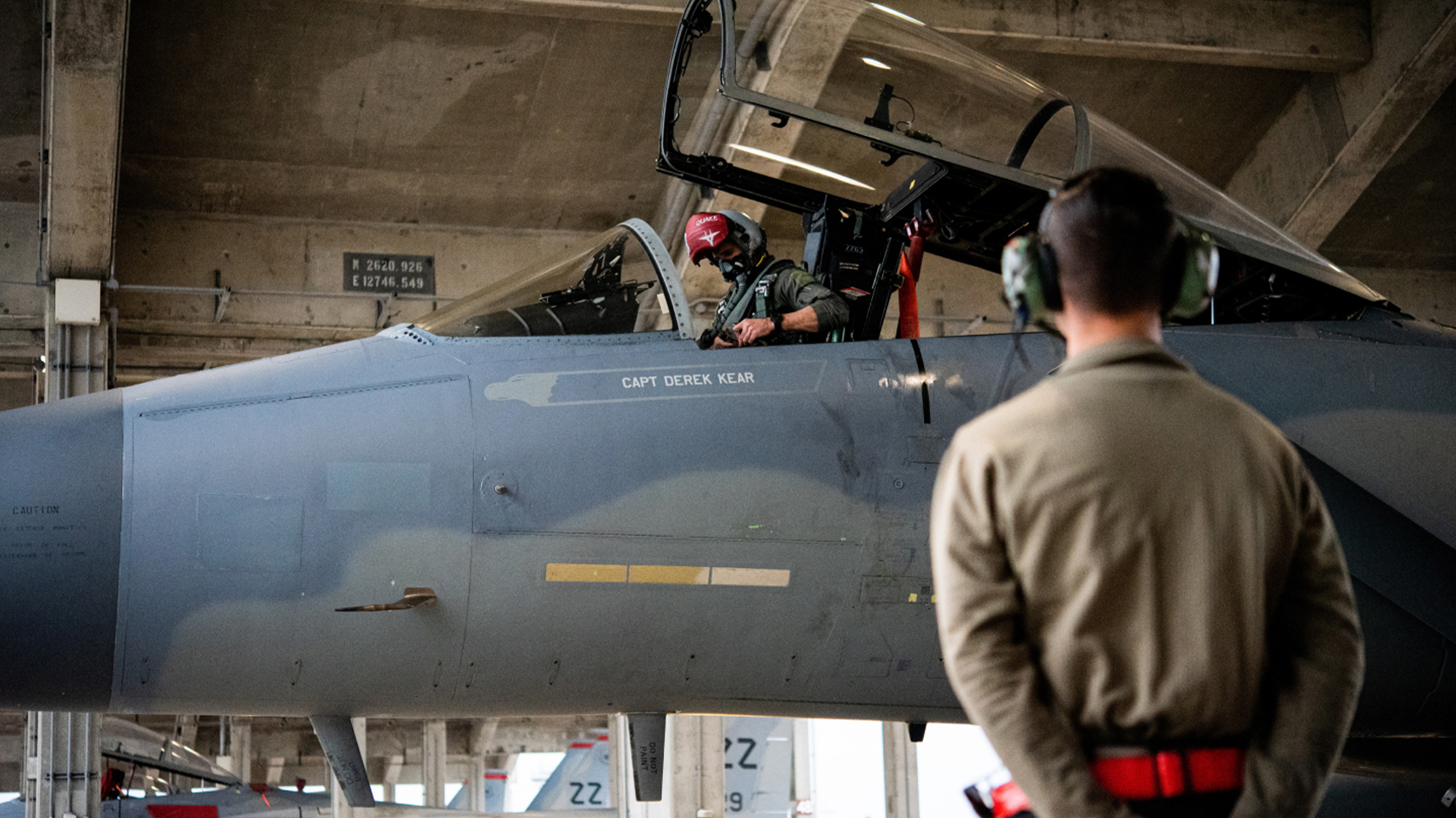 airmen watching fighter pilots getting into aircraft