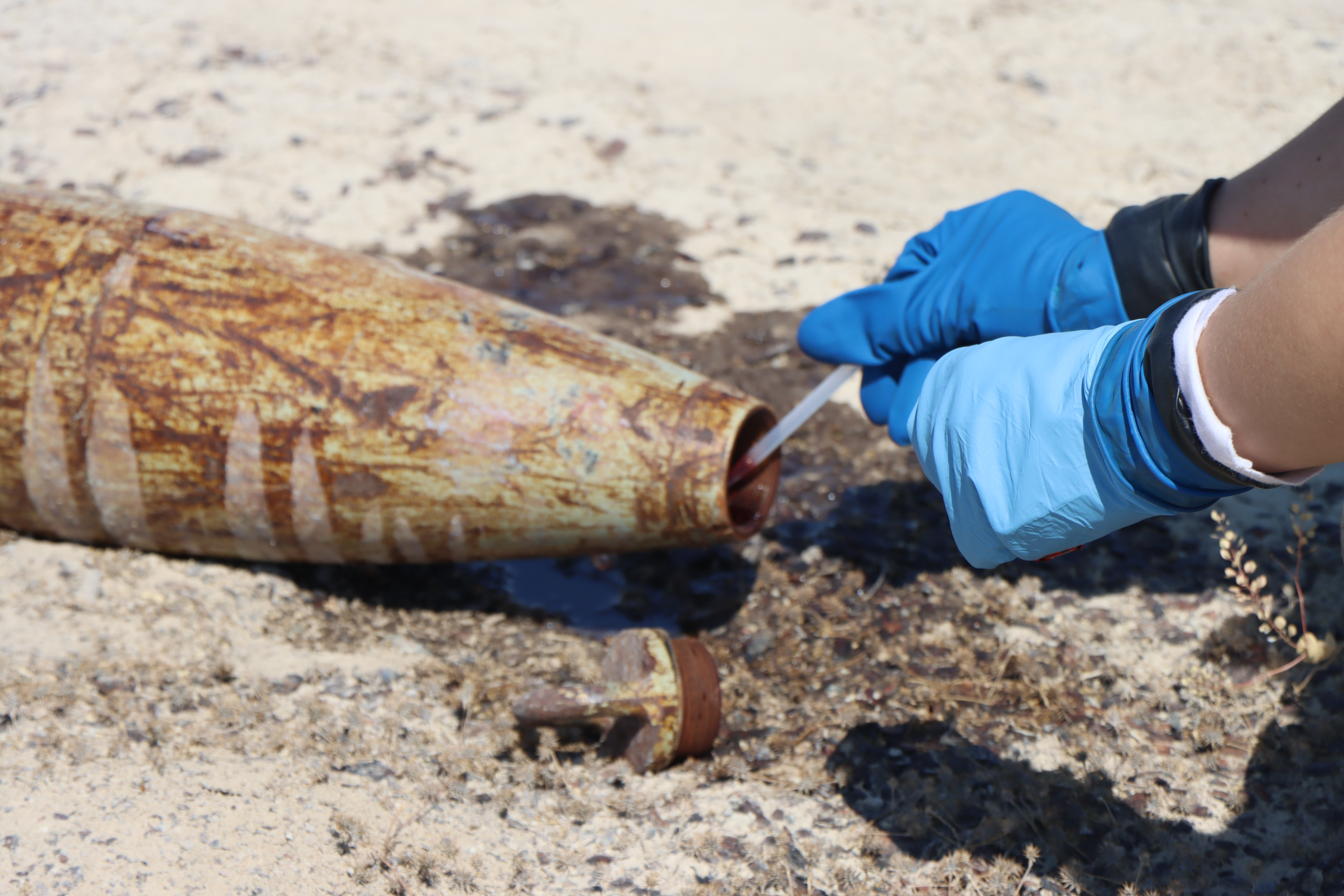 Airman's gloved hands inspecting object