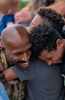 airman hugging his kids