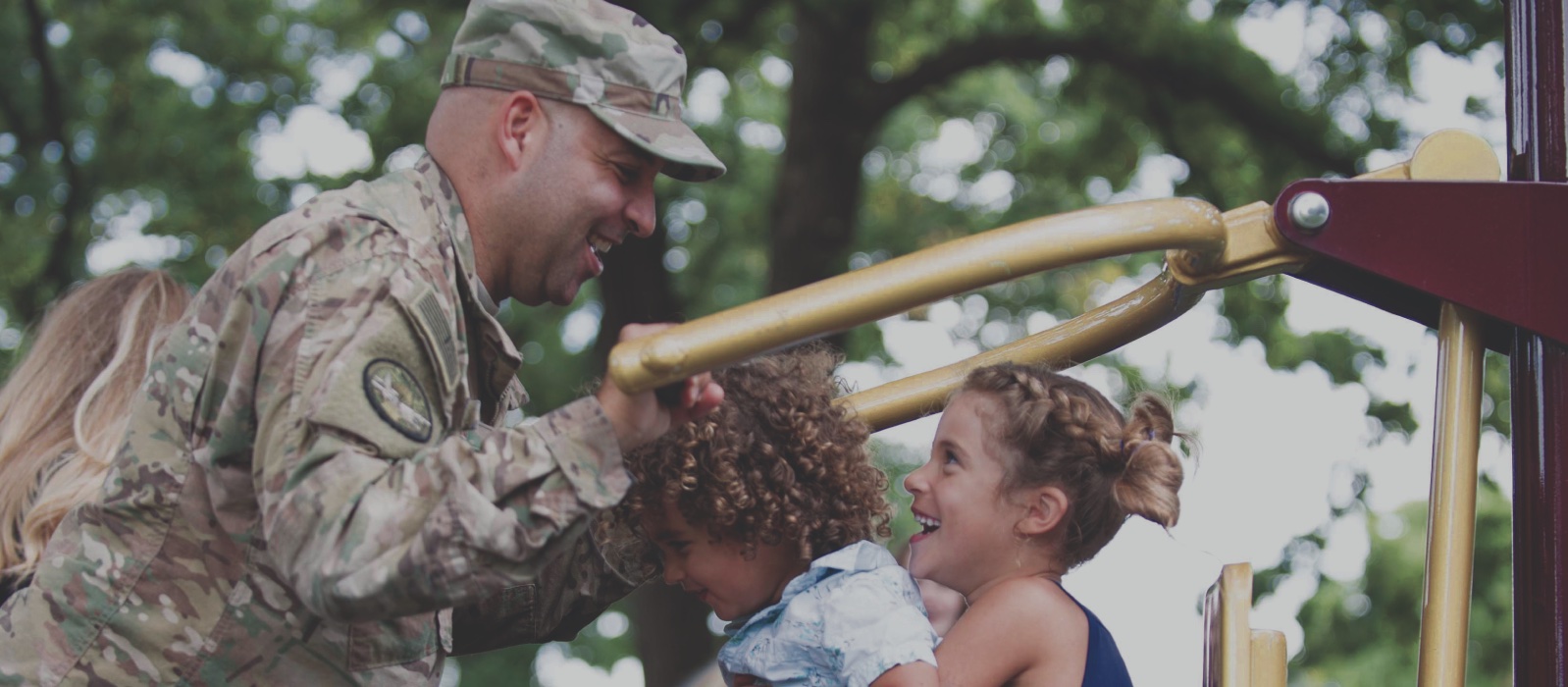 Airman playing with two small children