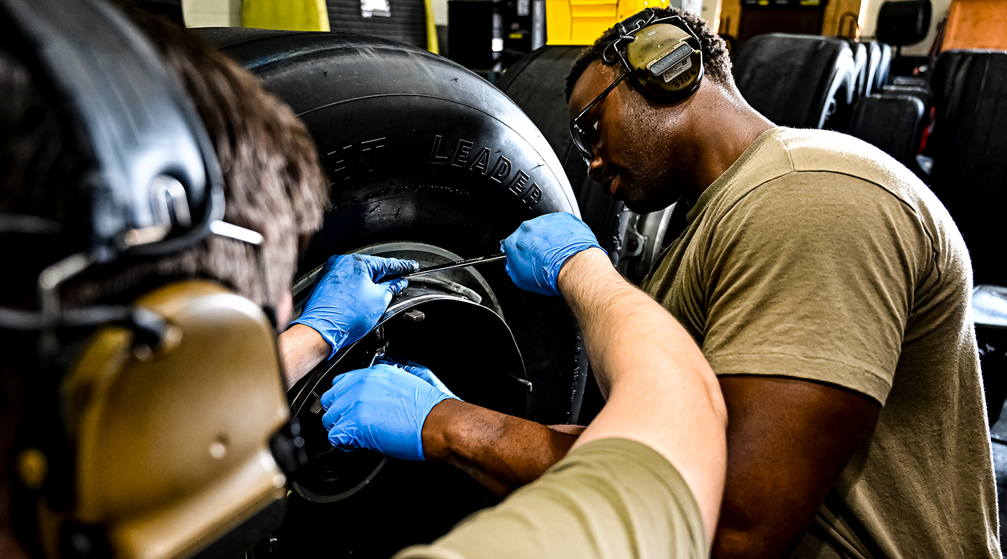 airmen ensuring aircraft tires are in optimal condition pre-flight