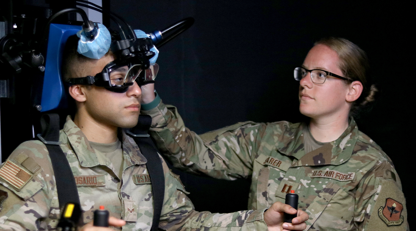 audiologist helping airman with audio exam