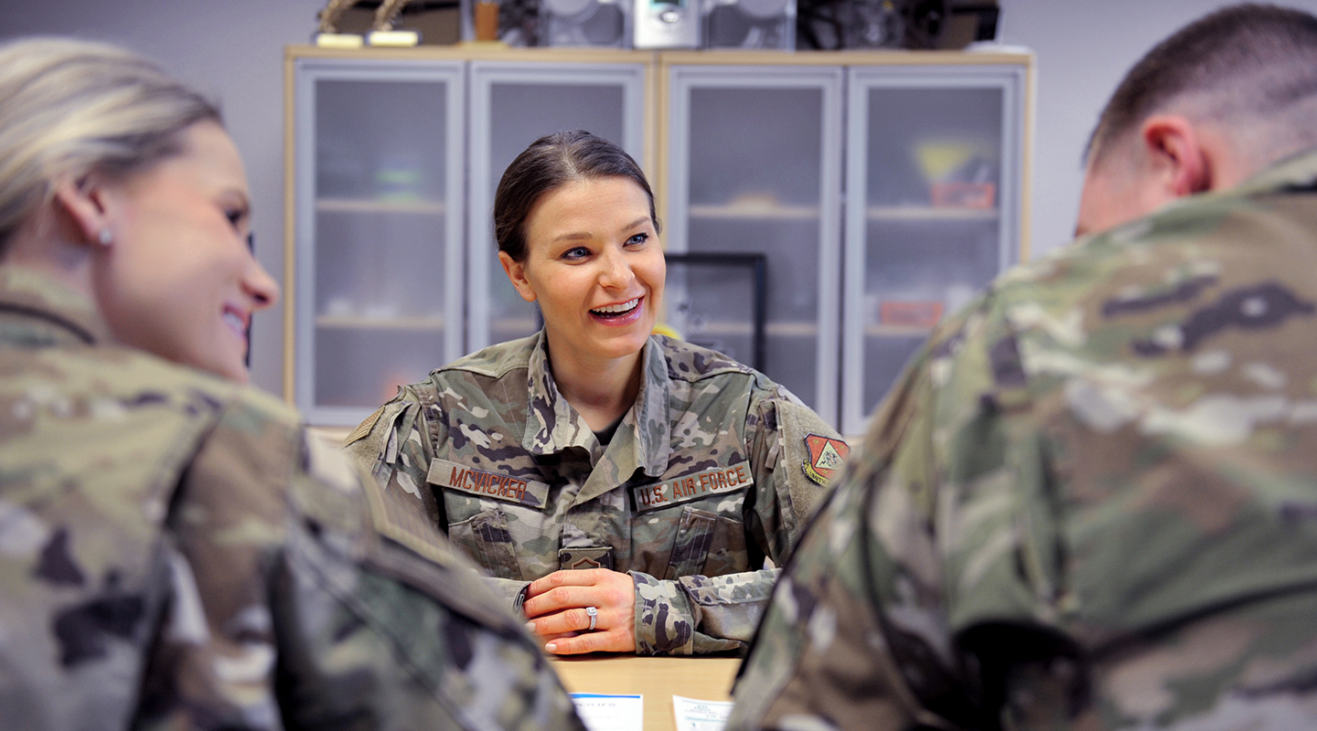 dietitian smiling and talking to two other airmen