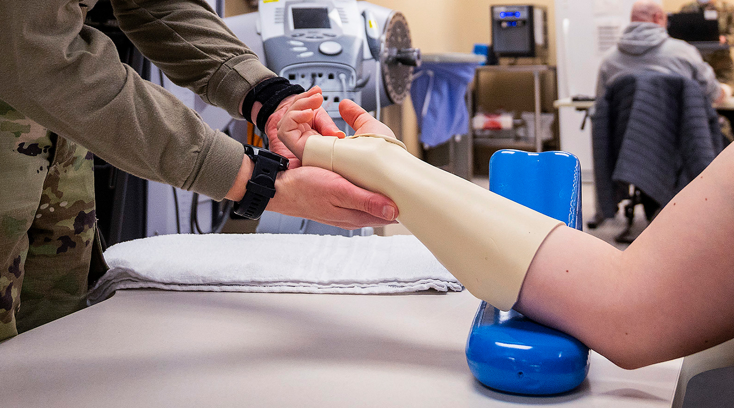 occupational therapist inspecting a prosthesis 