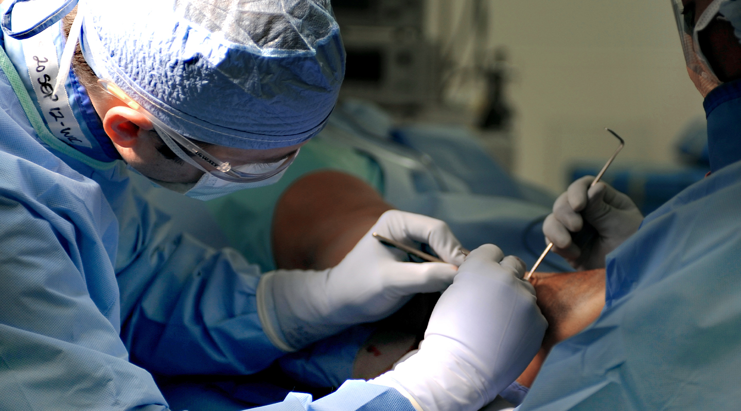 podiatric surgeon operating on a foot