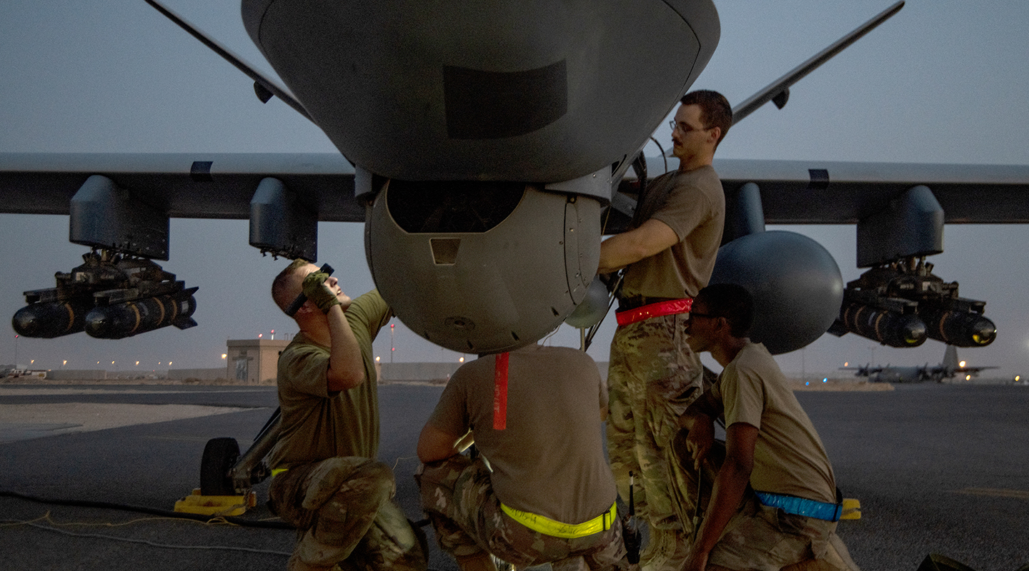 airmen performing maintenance work on an RPA