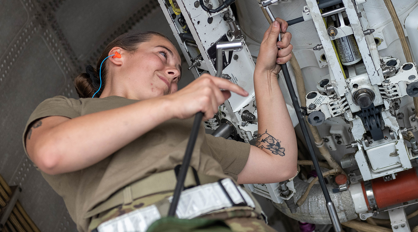 airman working performing maintenance on an equipment