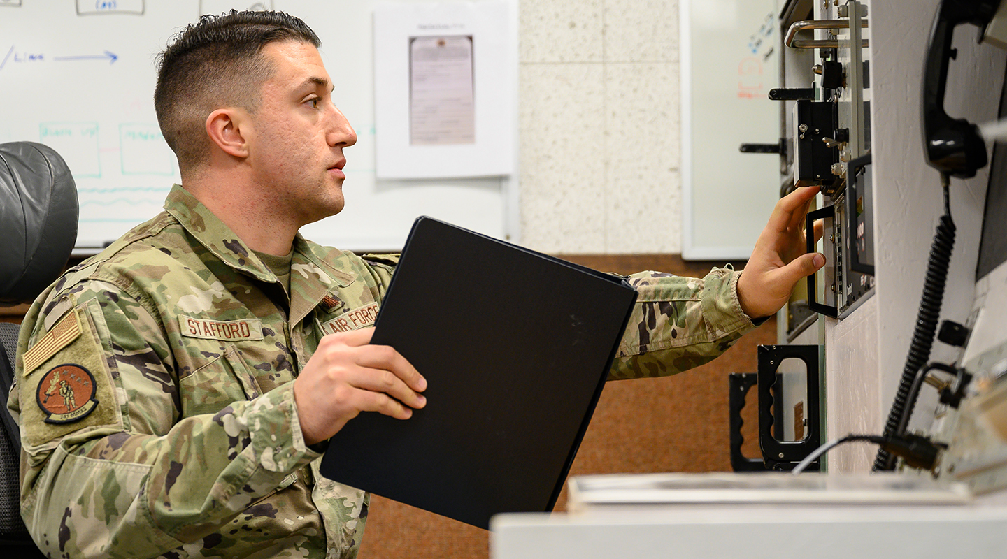 airman operating a control board