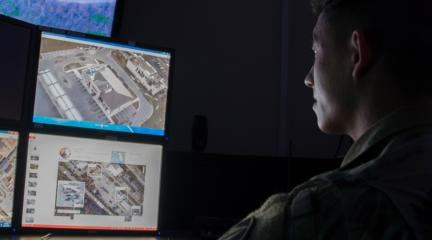 Signals Intelligence Analyst reviewing screens