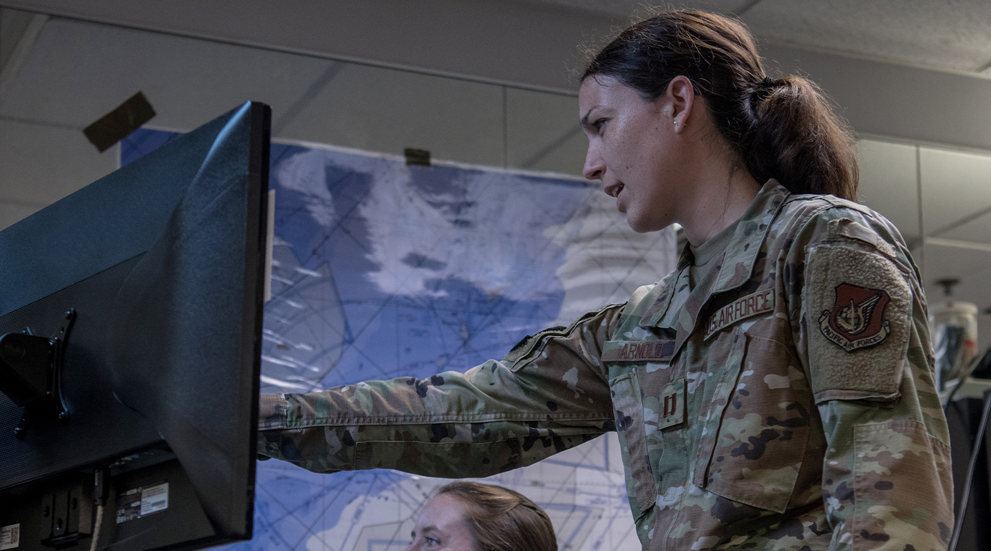 woman pointing at data on a screen