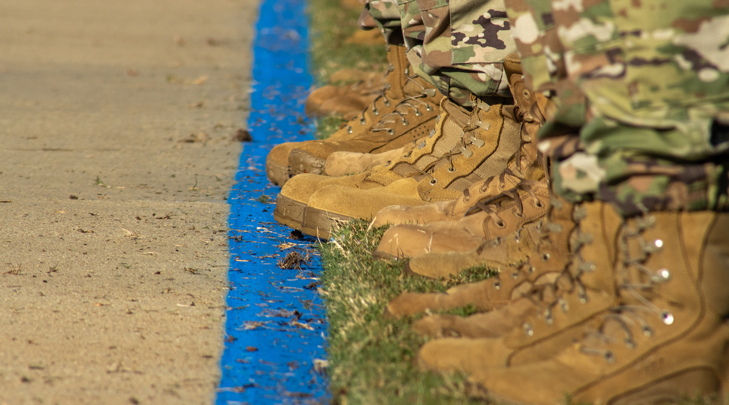 image of combat boots worn by recruits lined up next to each other