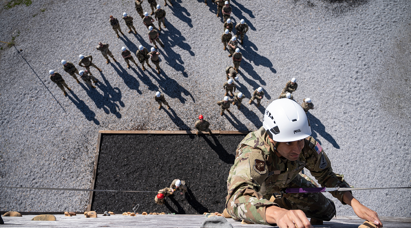 Trainee hanging in an obstacle course