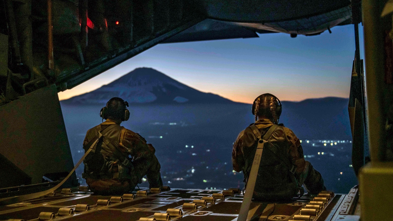 Two airmen overlooking a mountain from aircraft