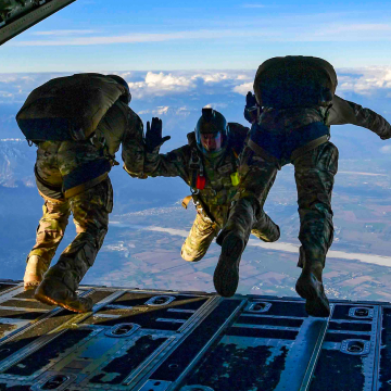 airmen jumping out of the back of an aircraft conducting training exercises