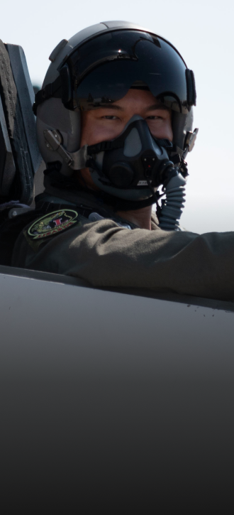 pilot wearing headgear looking towards the camera