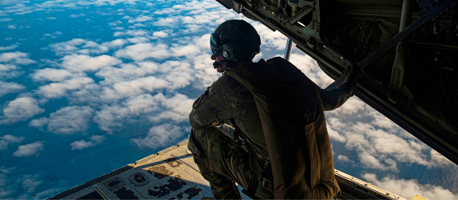 Airman preparing to jump off the back of an aircraft 