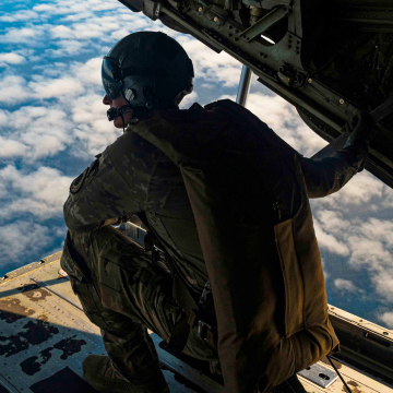 Airman preparing to jump off the back of an aircraft 