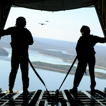 Air National Guardsman standing at the back hatch of an airplane in flight