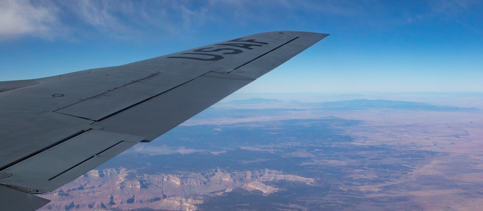 Air National Guard plane flying over canyon