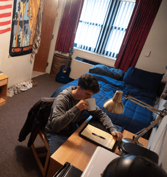 Airman in dorm drinking from a mug