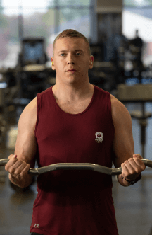 Airman in red tank top working out